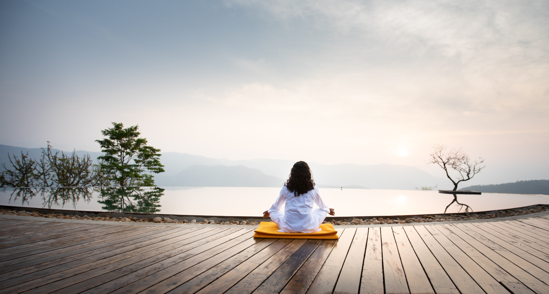 Prakriti Shakti, CGH Earth — sunrise meditation by the still water