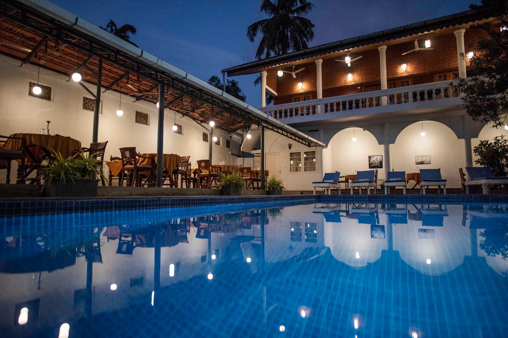 Abad Dutch Bungalow — poolside courtyard at dusk
